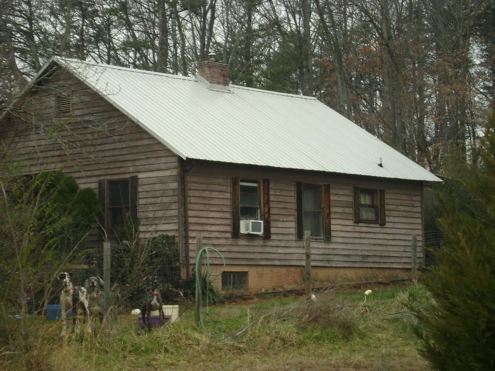White metal roof on an old wood sided farmhouse, from a Metal Roof Installation job in Sweeden